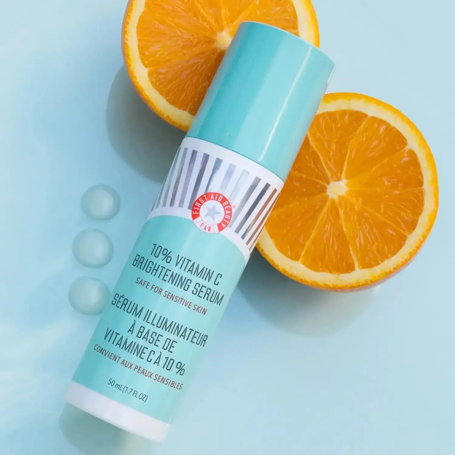 First Aid Beauty 10% Vitamin C Brightening Serum with orange slices, designed for sensitive skin, boosts radiance and luminosity.
