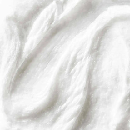 First Aid Beauty Face Cleanser texture close-up, showcasing a creamy white formula for gentle cleansing.