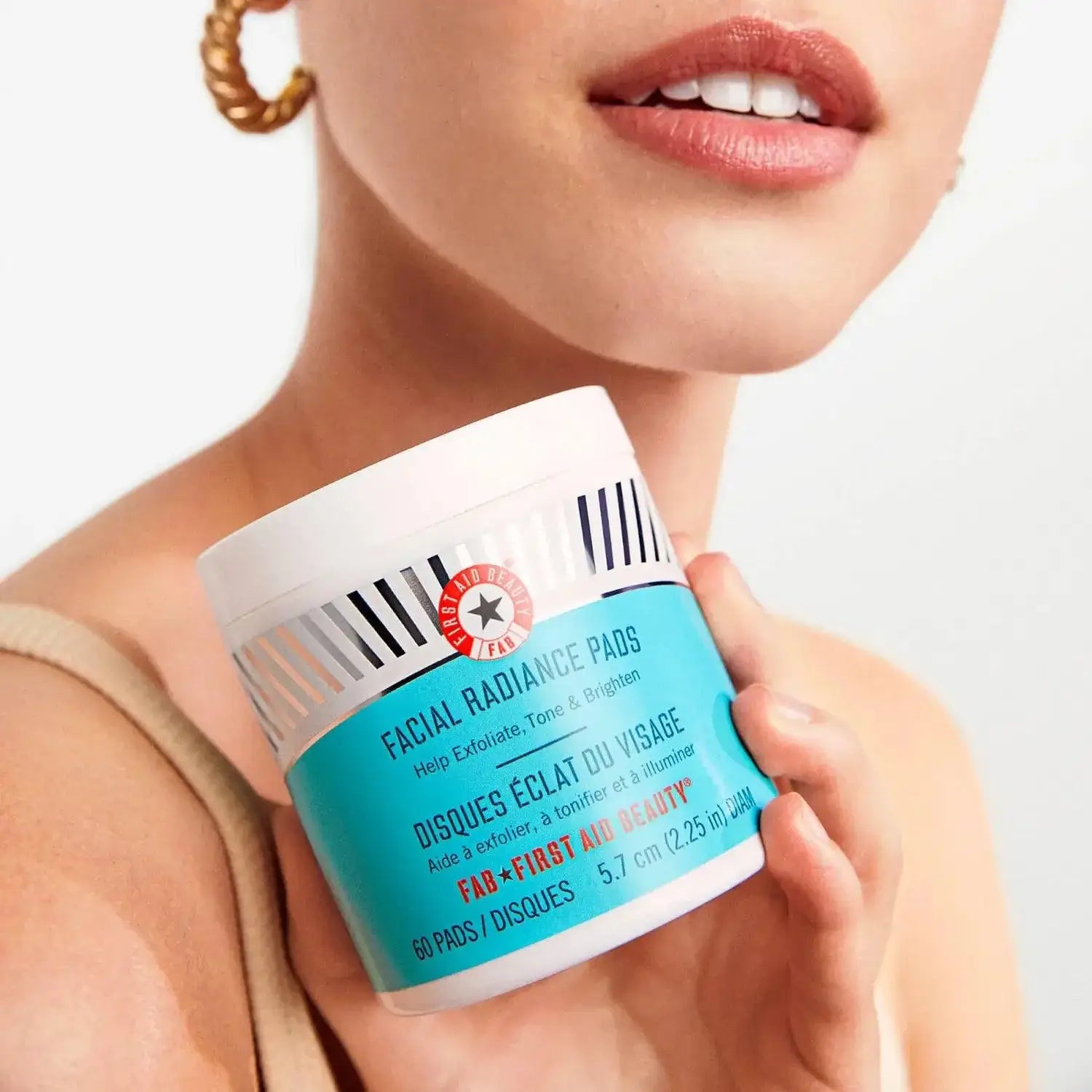 First Aid Beauty Facial Radiance Pads container for exfoliating skin with glycolic and lactic acids, ideal for daily use.