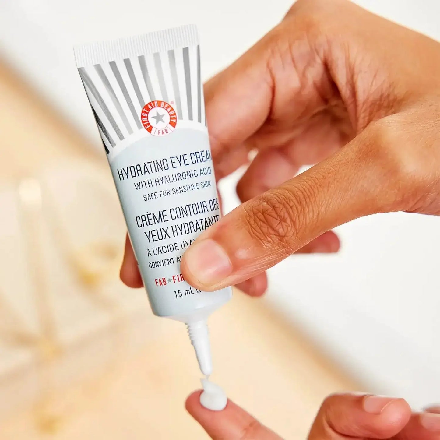 First Aid Beauty Hydrating Eye Cream 15ml with hyaluronic acid, applied to moisturize and reduce under-eye puffiness.