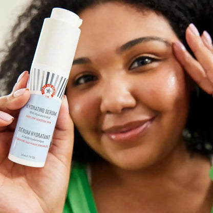 First Aid Beauty Hydrating Serum with Hyaluronic Acid, 50ml, shown with a smiling woman, ideal for sensitive skin.