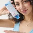 First Aid Beauty Oil-Minimizing Toner in hand, showcasing salicylic acid formula for oil control and skin purification.