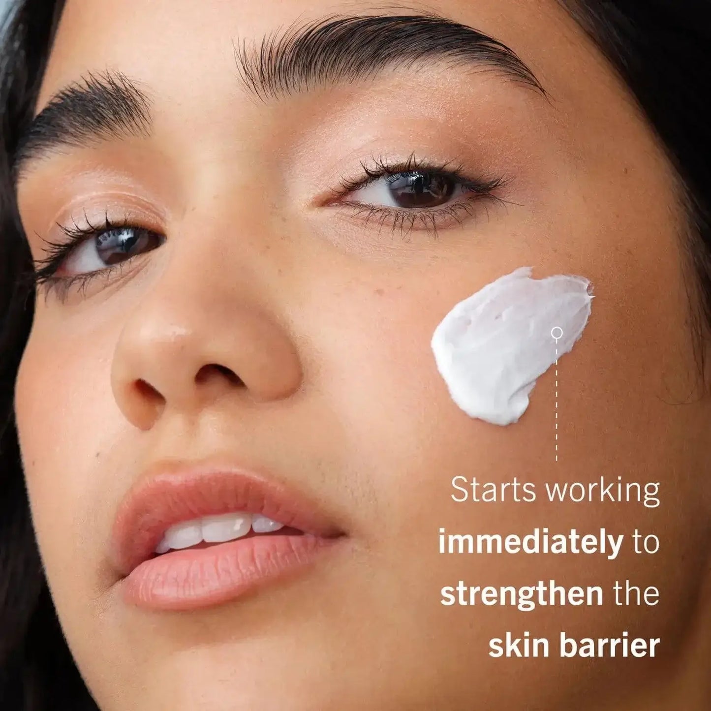 First Aid Beauty Ultra Repair Cream on model's face, nourishing and strengthening sensitive skin barrier.