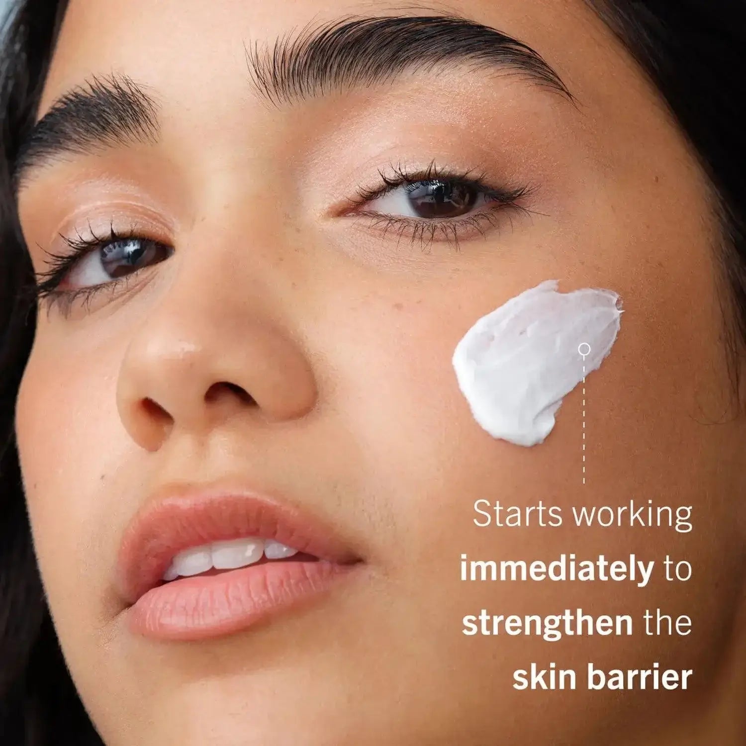 First Aid Beauty Ultra Repair Cream on model's face, nourishing and strengthening sensitive skin barrier.