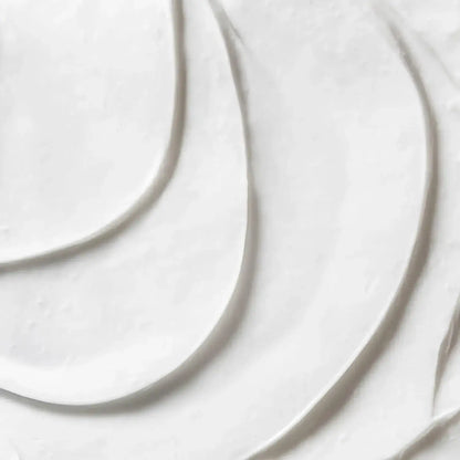 Close-up of First Aid Beauty Ultra Repair Cream texture, showcasing its rich, whipped consistency.