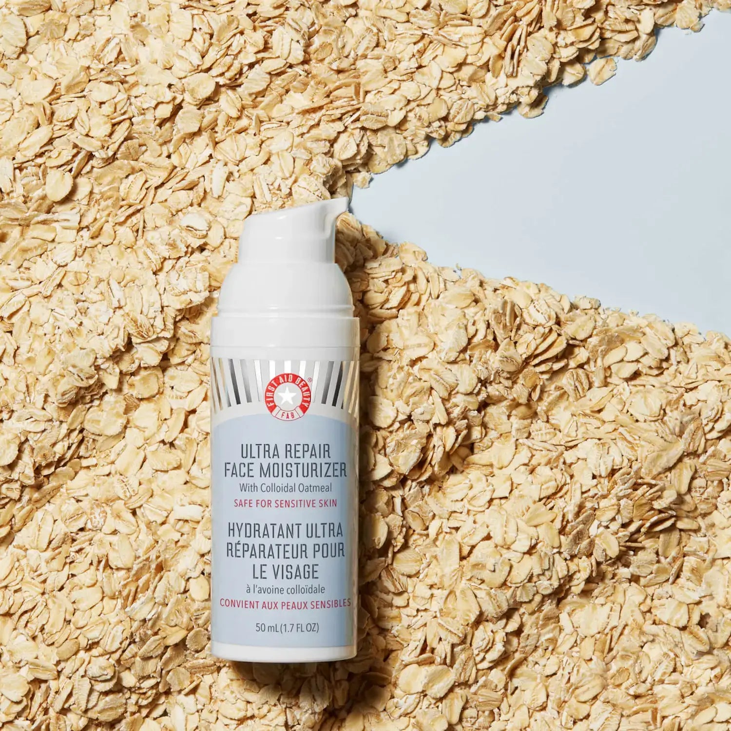First Aid Beauty Ultra Repair Face Moisturizer 50ml with colloidal oatmeal on an oat background for sensitive skin.