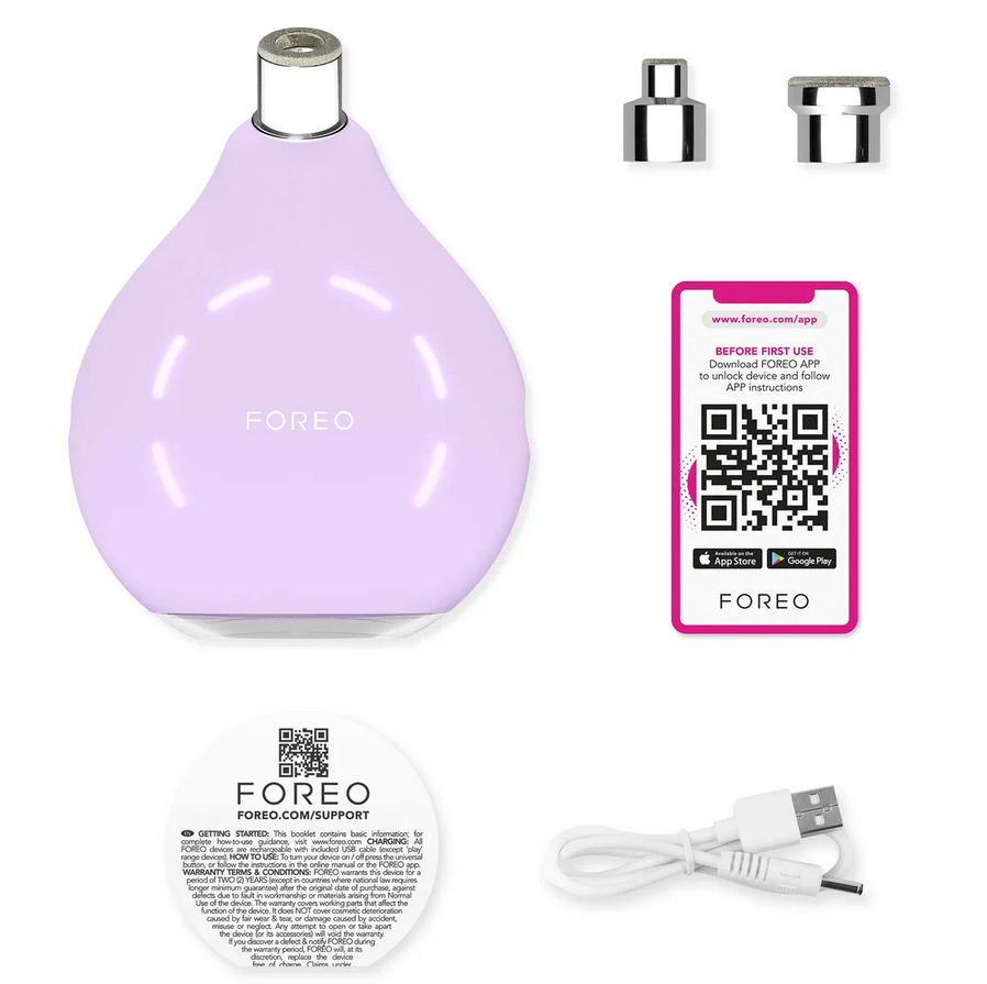 Purple FOREO device with USB cable, app card, and small attachments on a white background