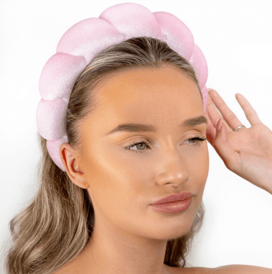 Model wearing Brushworks Pink Cloud Headband, featuring a luxurious bubble design in soft pink for beauty routines.