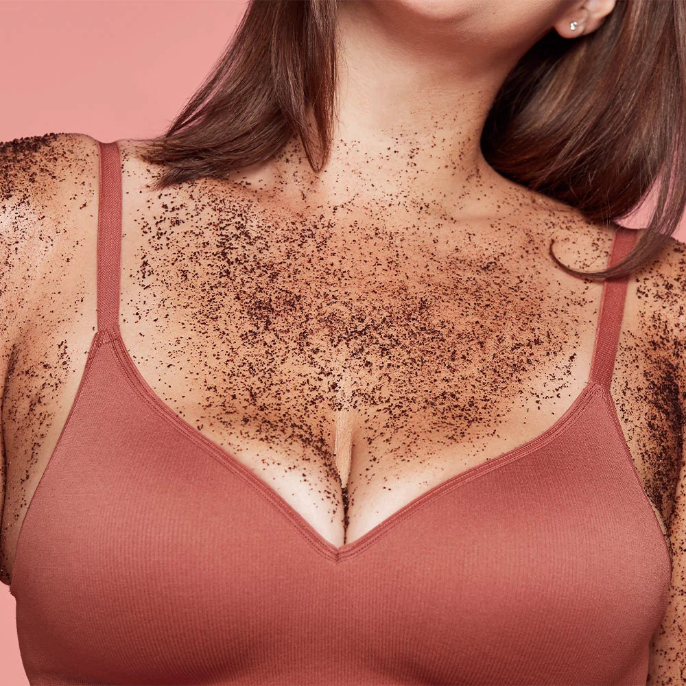 Woman wearing a pink bra with visible chest hair on a pink background