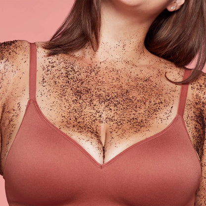 Woman wearing a pink bra with visible chest hair on a pink background