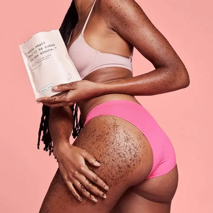 Person wearing pink underwear holding a product against a pink background