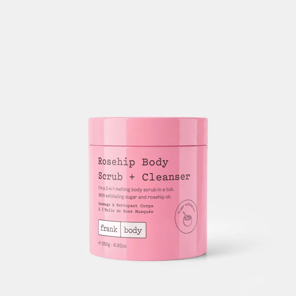 A pink cylindrical tub of Frank Body Rosehip Body Scrub + Cleanser on a light gray background.