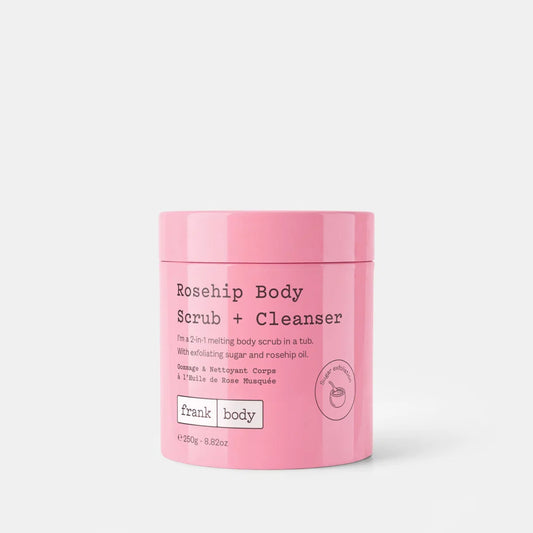 A pink cylindrical tub of Frank Body Rosehip Body Scrub + Cleanser on a light gray background.