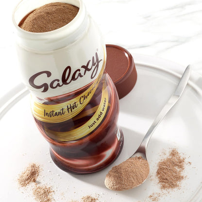Galaxy Instant Hot Chocolate with a spoonful of powder on a white plate