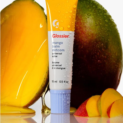 Glossier mango balm dotcom with two mangoes in the background