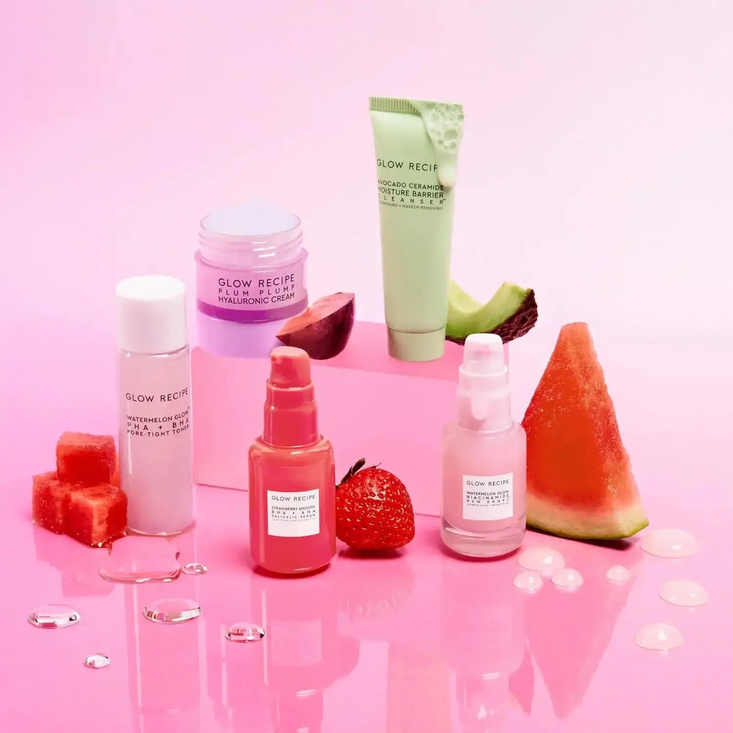 Glow Recipe Fruit Babies Set featuring five skincare minis on a pink background with fruit elements.