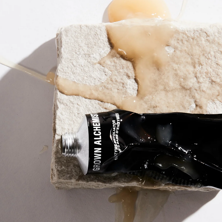 Bottle of Grown Alchemist product on a textured surface with a white background