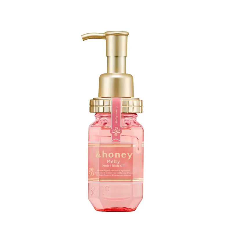 Pink bottle with gold pump on a white background