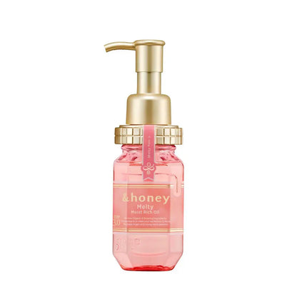 Pink bottle with gold pump on a white background