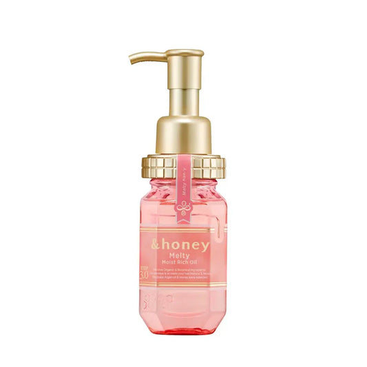 Pink bottle with gold pump on a white background