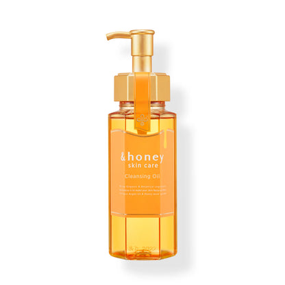 &honey Orange bottle of cleansing oil with a gold pump on a white background