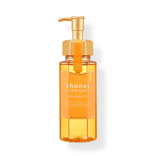 &honey Orange bottle of cleansing oil with a gold pump on a white background