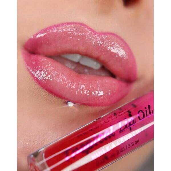 Close-up of glossy lips with I Heart Revolution Tasty Tropical Lip Oils Pomegranate, showcasing hydration and shine.