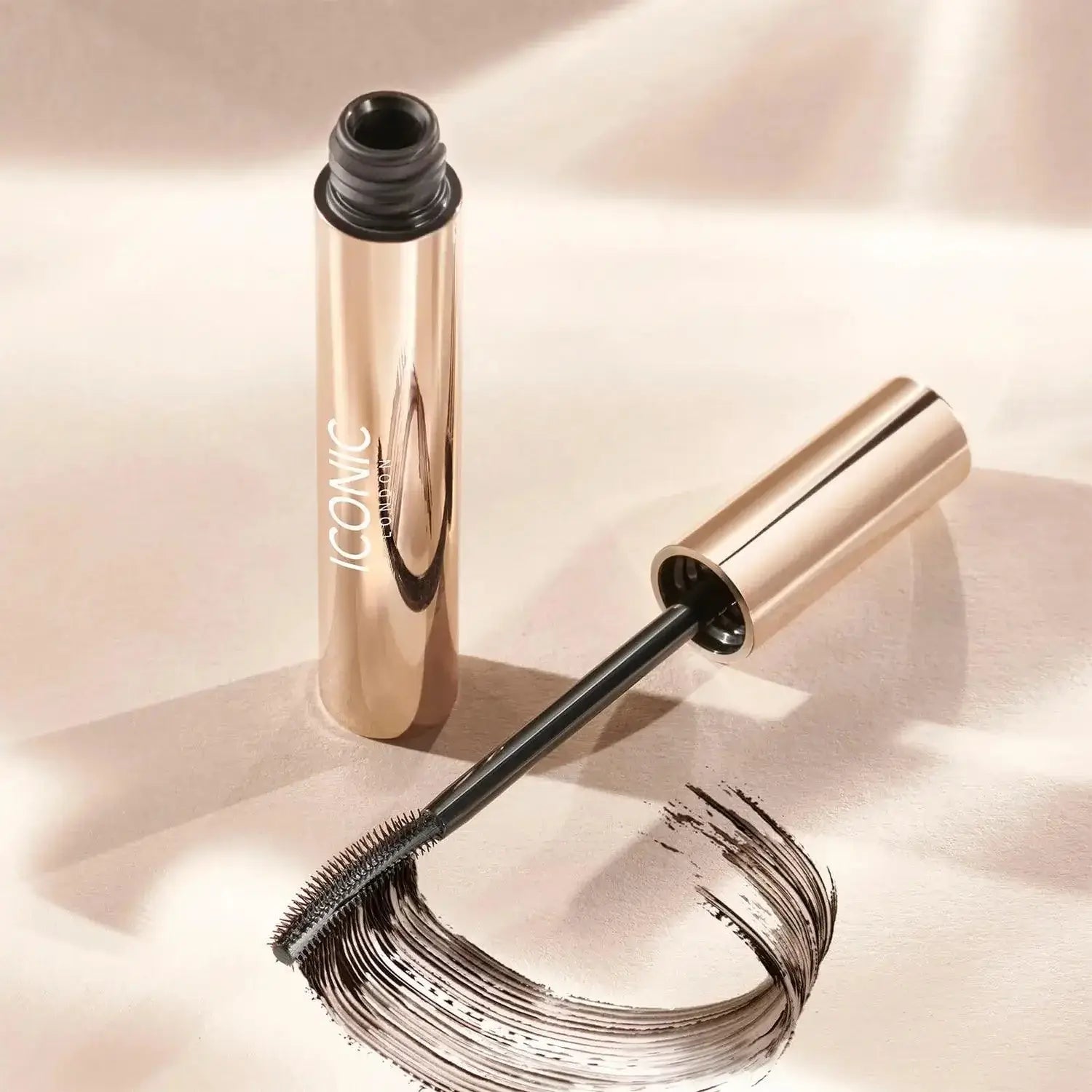 ICONIC London Enrich and Elevate Mascara tube with jet-black formula swatch on a cream background.