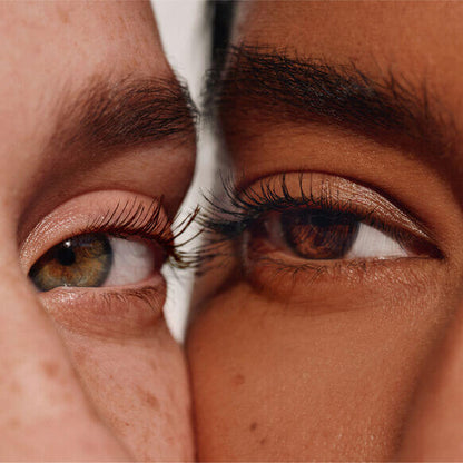 Close-up of two diverse eyes showcasing long, lush lashes, highlighting ILIA Limitless Lash Mascara's transformative effect.