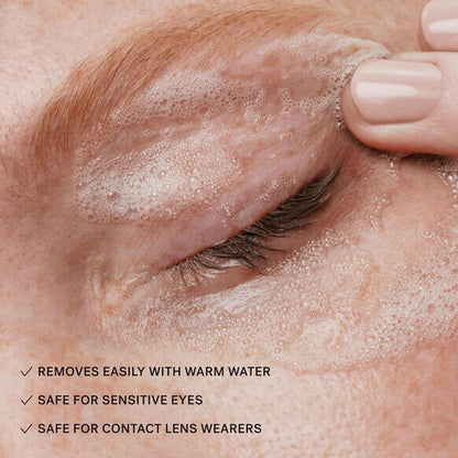 ILIA Close-up of an eye with cleanser foam, highlighting eye makeup removal features for sensitive eyes and contact lens wearers.
