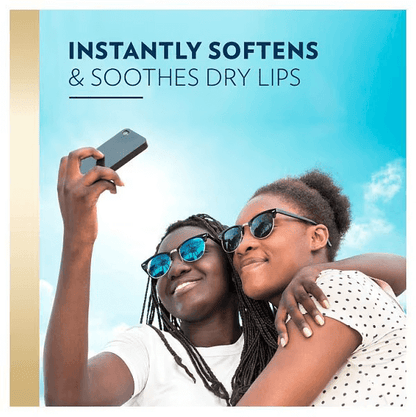 Two people taking a selfie outdoors with sunglasses, promoting lip product.