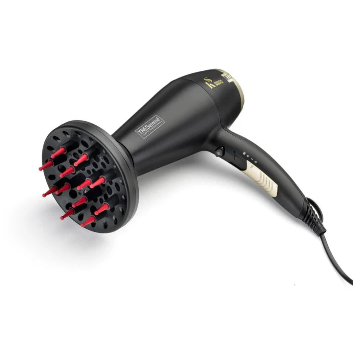 Black hair dryer with red nozzles on a white background