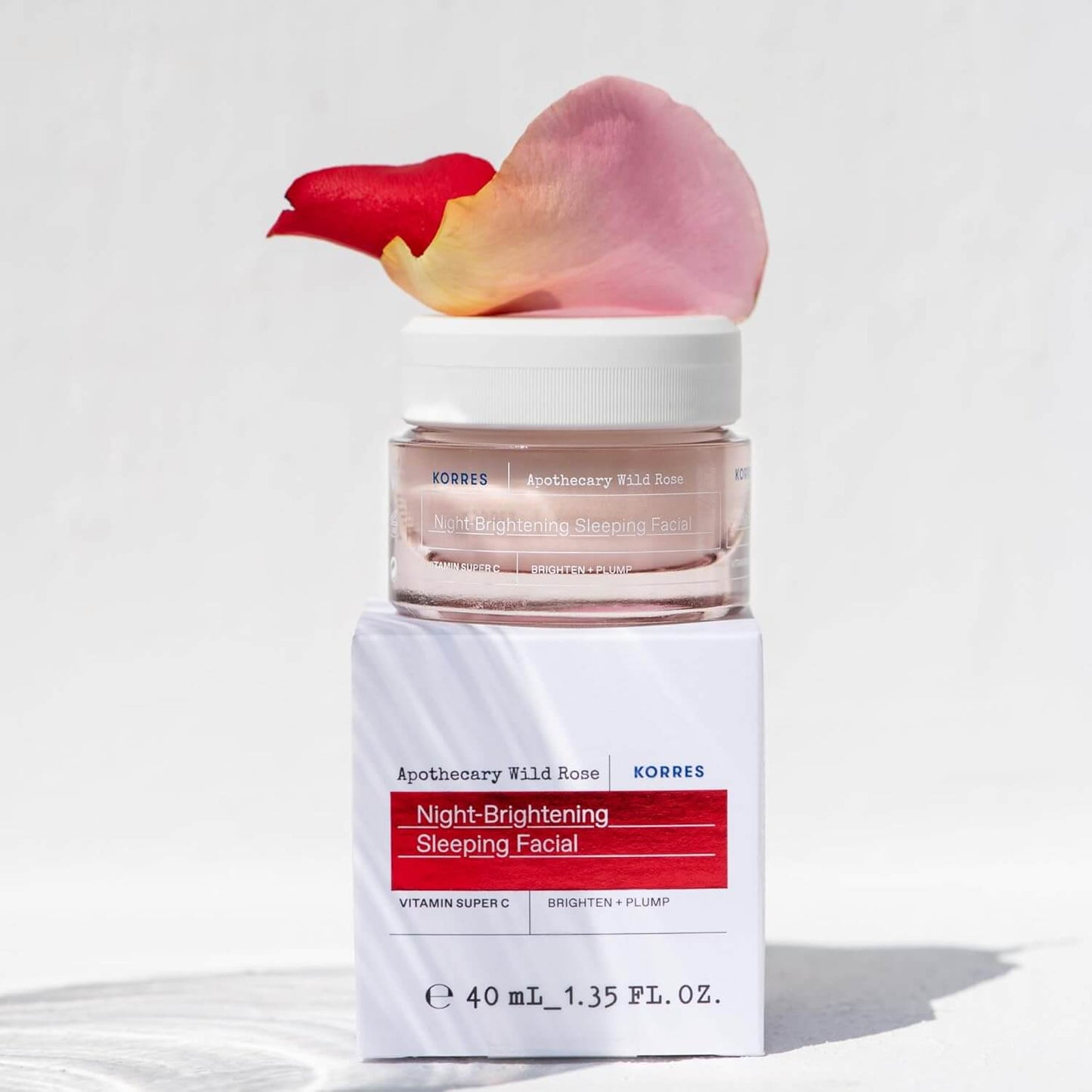 Korres Night-Brightening Sleeping Facial with a rose petal on a white background