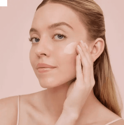 Woman applying LANEIGE Bouncy and Firm Sleeping Mask on her face for a radiant glow.