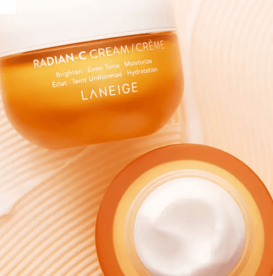 LANEIGE Radian-C Cream 30ml jar for brightening and moisturizing skin, featuring vitamin C and E, on a textured background.