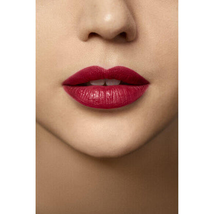 Close-up of lips wearing Laura Mercier Rouge Essentiel Silky Crème Lipstick in vibrant red shade.