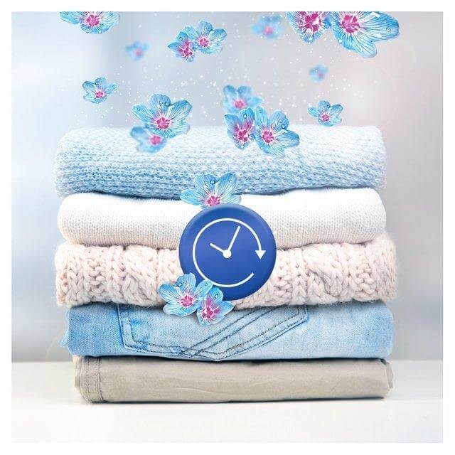 Stack of folded clothes featuring blue and pink flowers, symbolizing freshness with Lenor scent booster.