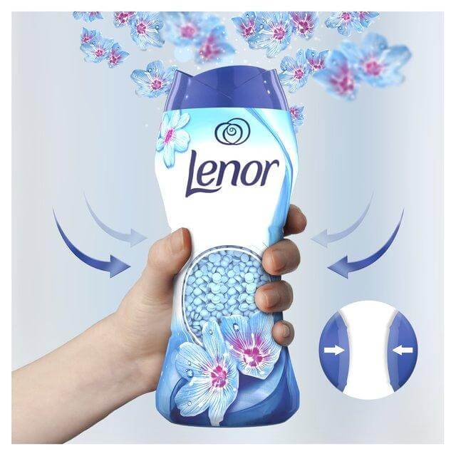 Lenor In-Wash Scent Booster in hand, releasing Spring Awakening scent with floral notes and freshness.