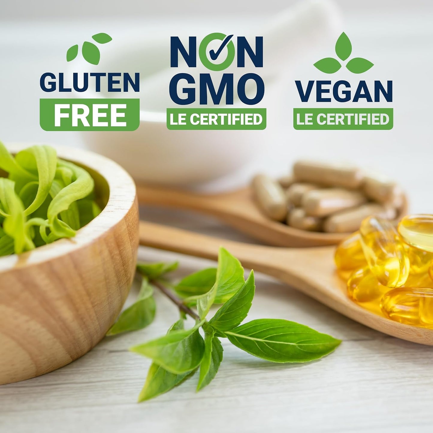 Life Extension Vegan certification labels on a table with green leaves and a wooden spoon.