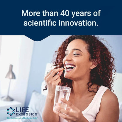 Woman taking a supplement with a glass of water, Life Extension branding visible