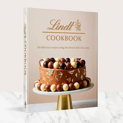 Lindt Cookbook featuring 60 recipes with gourmet chocolate on a marble background.