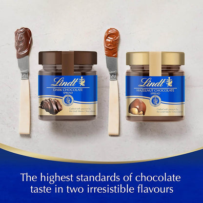 Two jars of Lindt chocolate spread with spoons on a white background