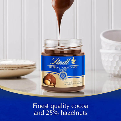 Lindt hazelnut chocolate spread being poured into a jar with a white background