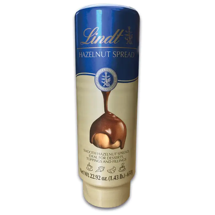 Lindt Hazelnut Milk Chocolate Spread 650g bottle, ideal for desserts, toppings, and transforming breakfasts.