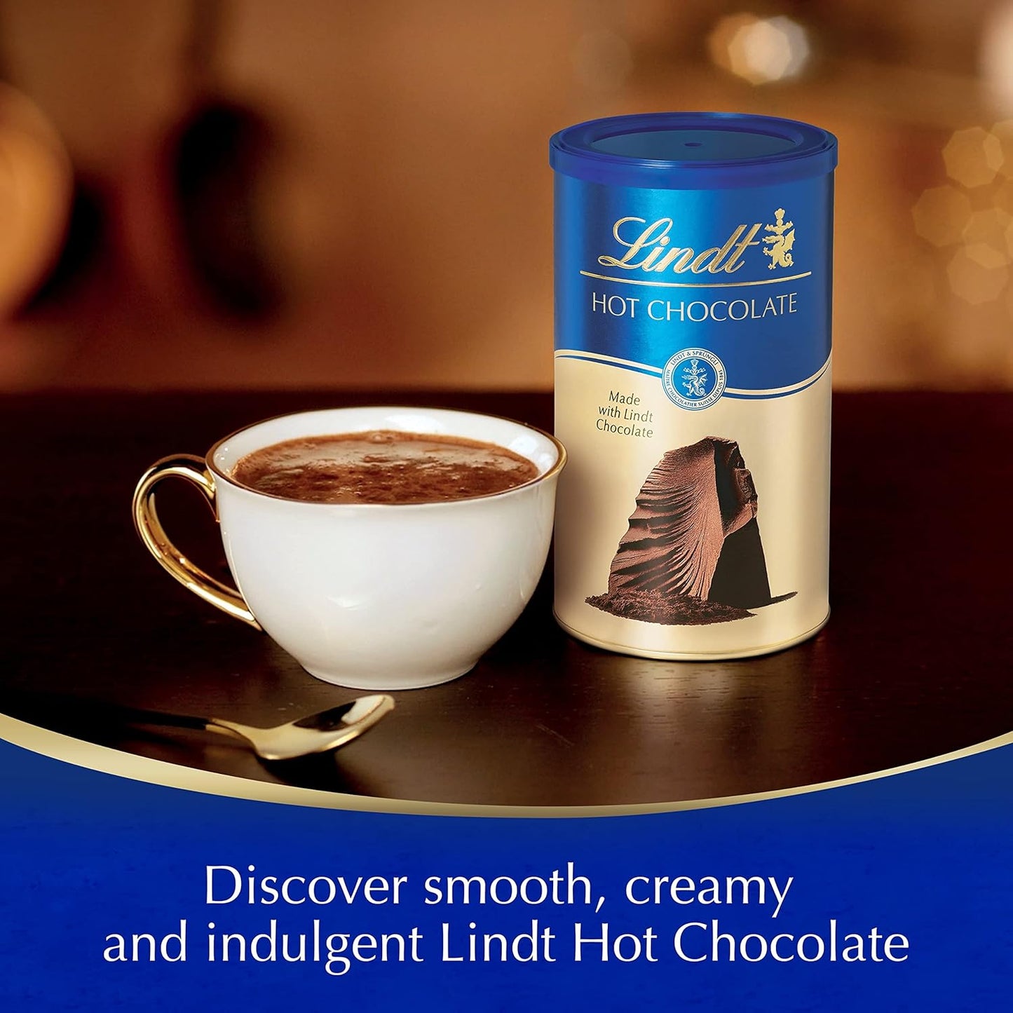 Lindt hot chocolate canister with a cup of hot chocolate on a table.