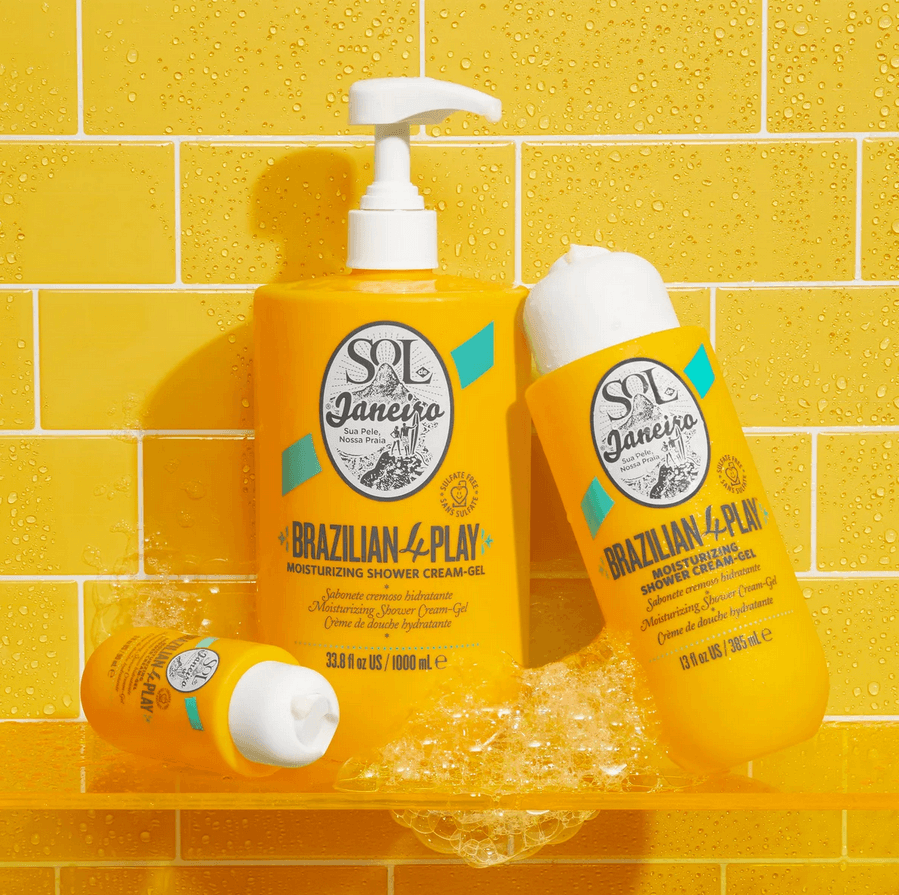 Sol de Janeiro Brazilian 4 Play Moisturizing Shower Cream-Gel products on a vibrant yellow background with bubbles.