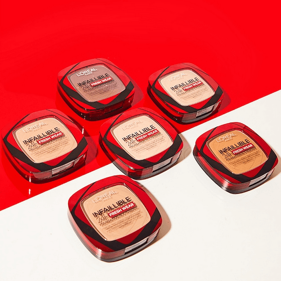 Set of six L'Oreal Paris makeup products on a red background