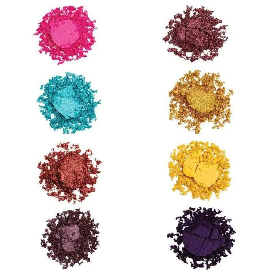 Colorful pigments from the Makeup Revolution Creative Vol 1 Palette in vibrant pink, teal, gold, and deep purple hues.