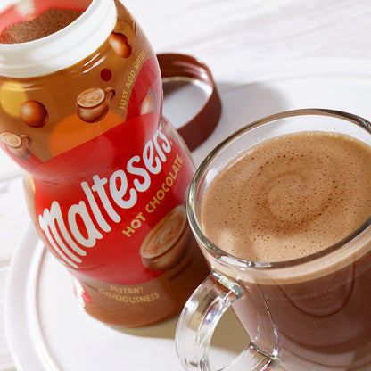 Maltesers hot chocolate jar and a glass of hot chocolate on a white surface