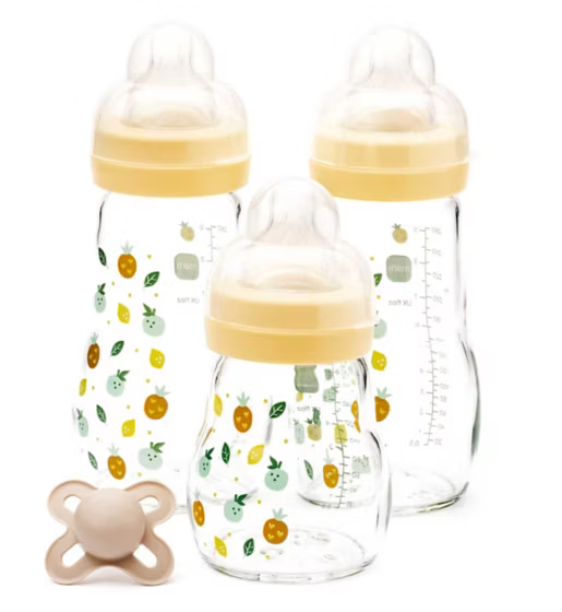 Three MAM baby bottles with yellow caps and fruit pattern, one pacifier on a white background